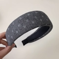 Close-up of a charcoal grey wool knit headband with white snowflake floral patterns - Wide Grey