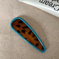 Close-up of blue leopard print teardrop hair clip with vibrant acetate finish - Solid Water Drop