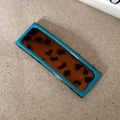 Detail of teal and tortoiseshell wavy hair clip in a minimalist rectangle shape - Solid Square
