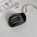 Detailed shot of large grey marble claw clip with gold Barrette La France lettering - Oval Dark Gray
