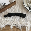 Elegant black bow-shaped banana hair clip on textured fabric with decorative pearls - Bow Shape / Bright Black
