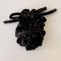 Detail view of premium black velvet scrunchie showing soft texture and elegant ribbon streamers - Black