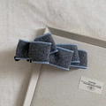Close-up of wool bow banana hair clip with blue braided trim and resin claws - Haze Gray
