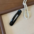 Minimalist black acetate duckbill hair clip with white France Handmade logo on wood tray - Black