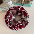 Nahaufnahme von vintage weinrotem Karo-Haargummi mit hellblauem Paspel-Detail - Rot mit blauem Rand