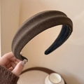 Close-up of a wide dark brown knitted headband featuring thick wool texture and fabric lining - Dark Coffee