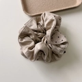 Close-up of elegant beige satin and polka dot knit hair scrunchie with layered texture - Cylinder Studded
