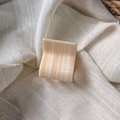 Close-up of a square cream acetate hair claw clip with marble texture on linen fabric - Cream Beige Marble Style / Beige