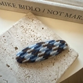 Detailed view of houndstooth knit hair clip on textured stone tray with aesthetic background - Ellipse / Blue