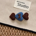 Detailed close-up of heart patches on canvas hair clip with brand woven label - Blue Coffee Heart Hair Clip