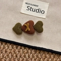Detail shot of heart-shaped fabric hair clips with knit texture and cross stitching - Coffee Green Heart Hair Clip