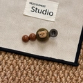 Cute bear hair clip with brown beads and green knitted base on a beige background - Coffee Green Bear Hair Clip