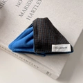 Detailed view of handmade blue and orange checkered fabric hair tie with handmade label - Patchwork Striped Fabric Style / Blue Hair Claw