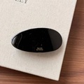 Detailed close-up of a glossy black oval acetate hair clip with golden Barrette la France text - Black