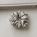 Detailed view of black and white striped knit fabric scrunchie with ribbed texture - Rice White Small