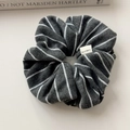 Detail of dark grey striped knit scrunchie featuring a white Hand Made woven label - Grey Large