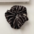Detailed close-up of knit scrunchie with brown stripes and a Hand Made woven label - Dark Coffee Large