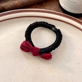 Detail of red satin bow hair tie with black elastic band on elegant ceramic plate - Red Bow Black Hair Tie