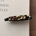 Close-up of tortoise shell acetate banana hair clip with internal teeth and glossy finish - Milk Coffee