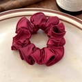 Close-up of burgundy satin scrunchie with silk luster on a vintage ceramic plate - Red Lace Scrunchie