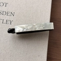 Detail of minimalist white marble texture rectangular hair clip on a textured background - Grey/White