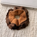 Detailed macro view of brown lace and knit fabric texture of the hair scrunchie - Orange Brown
