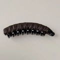 Detail view of brown pleated leather texture on a stylish banana hair clip for women - Leather Coffee