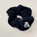 Detail of navy blue knitted scrunchie featuring a checkered heart charm and new tag - Navy Blue Scrunchie