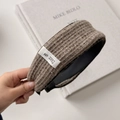 Detail of waffle knit fabric texture on the brown headband with a white woven label - Coffee Wide Headband