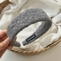 Detailed macro view of the gray handmade wool texture headband with inner brand label - Gray