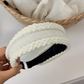 Macro detail of hand-knitted white twisted cable pattern on a wide winter headband - White