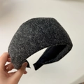 Gros plan d'un serre-tête large en mohair gris foncé avec une texture en laine - Noir et Gris