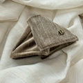Macro detail of brown velvet hair clip with a round golden handmade metal label - Khaki Triangle Claw Clip
