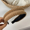 Close-up of brown knit twist headband featuring thick woven texture and black non-slip lining - Khaki