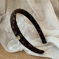Deep brown retro floral headband with elegant gold logo charm and non-slip wide band design - Coffee Floral