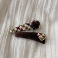Detail view of retro plaid hair clips with plush hearts on white fabric background - Coffee Heart