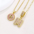 Golden necklace set with pink crystal letter M pendant and shimmering cubic zirconia - Gold M