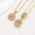 Golden necklace set with pink crystal G and C letter pendants featuring sparkling stones - Gold G