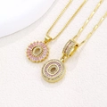 Luxurious gold necklace featuring a round pendant with pink baguette zircons and micro-diamonds - Gold O