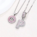 Silver letter P pendant necklace set with pink zircons and rhinestones on white marble - Silver P