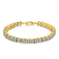 Close-up of golden tennis bracelet featuring round brilliant-cut cubic zirconia stones - Gold