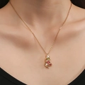 Golden Christmas tree necklace with colorful zircon stones on female model neckline - Christmas Tree Style / Gold