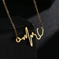 Minimalist gold stethoscope heartbeat necklace in stainless steel on black display - Gold
