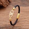 Braided leather bracelet with gold cross flower charm and zircon on dark wood - Cross Floral Inlaid Style (款式-4)