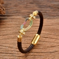 Handmade woven leather bracelet with golden gemstone heart charm on rustic wood surface - Multicolor Gemstone Inlaid Heart Style (款式-4)