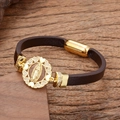 Detailed close-up of religious Virgin Mary leather bracelet with gold magnetic clasp - Heart Border Virgin Mary Style