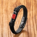 Macro view of braided leather cord bracelet with red cinnabar lotus charm and magnetic clasp - Religious Symbol