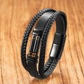 Detail of multi-layer black braided leather bracelet with golden metal accents and magnetic clasp - Hematite