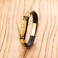 Braided leather bracelet with Tibetan bead and gold magnetic clasp on wood surface - Mixed Rope Gold Accessories Yellow Bead