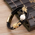 Detail of black braided leather bracelet with golden dragon heads and marble bead - Gold White Marble Bead